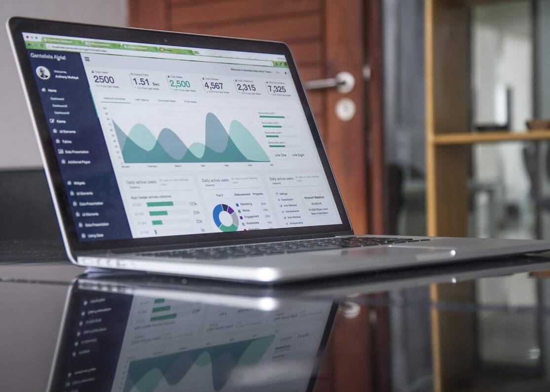 Computer with business stats on a table